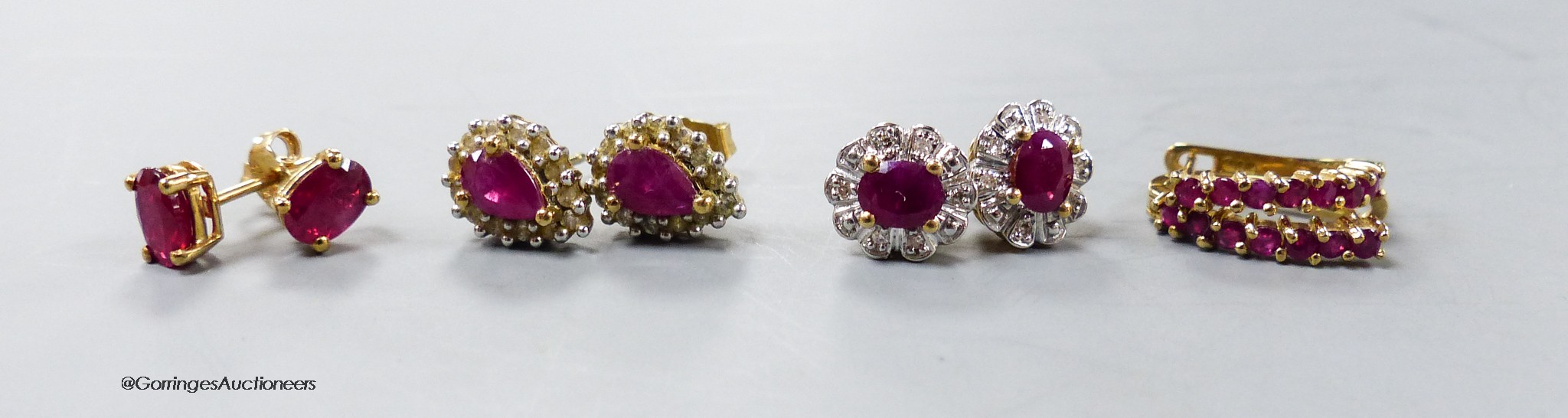 Four assorted modern pair of 9ct ruby or ruby and diamond set ear studs, gross 6.2 grams